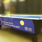 Custom branded air hockey table for a corporate event from Arcade Party Rental