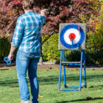 Outdoor interactive safety axe throw game for rent Arcade Party Rental.