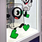 Claw crane game with corporate branding on the glass for a trade show in Las Vegas by Arcade Party Rental.
