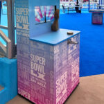 Golden Arm Wrestling arcade game with custom branding at Super Bowl tailgate party in Santa Clara California from Arcade Party Rental San Francisco