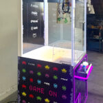 Wonder Claw with custom branding and attractive LED lights stands out at a trade show from Arcade Party Rental Los Angeles